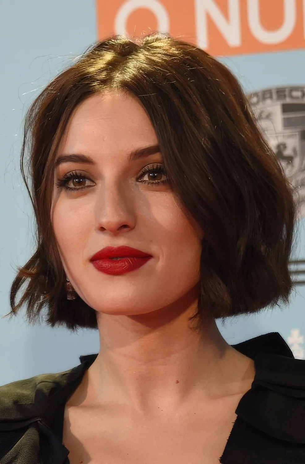 Dark brunette slightly wavy midi bob with center part.
