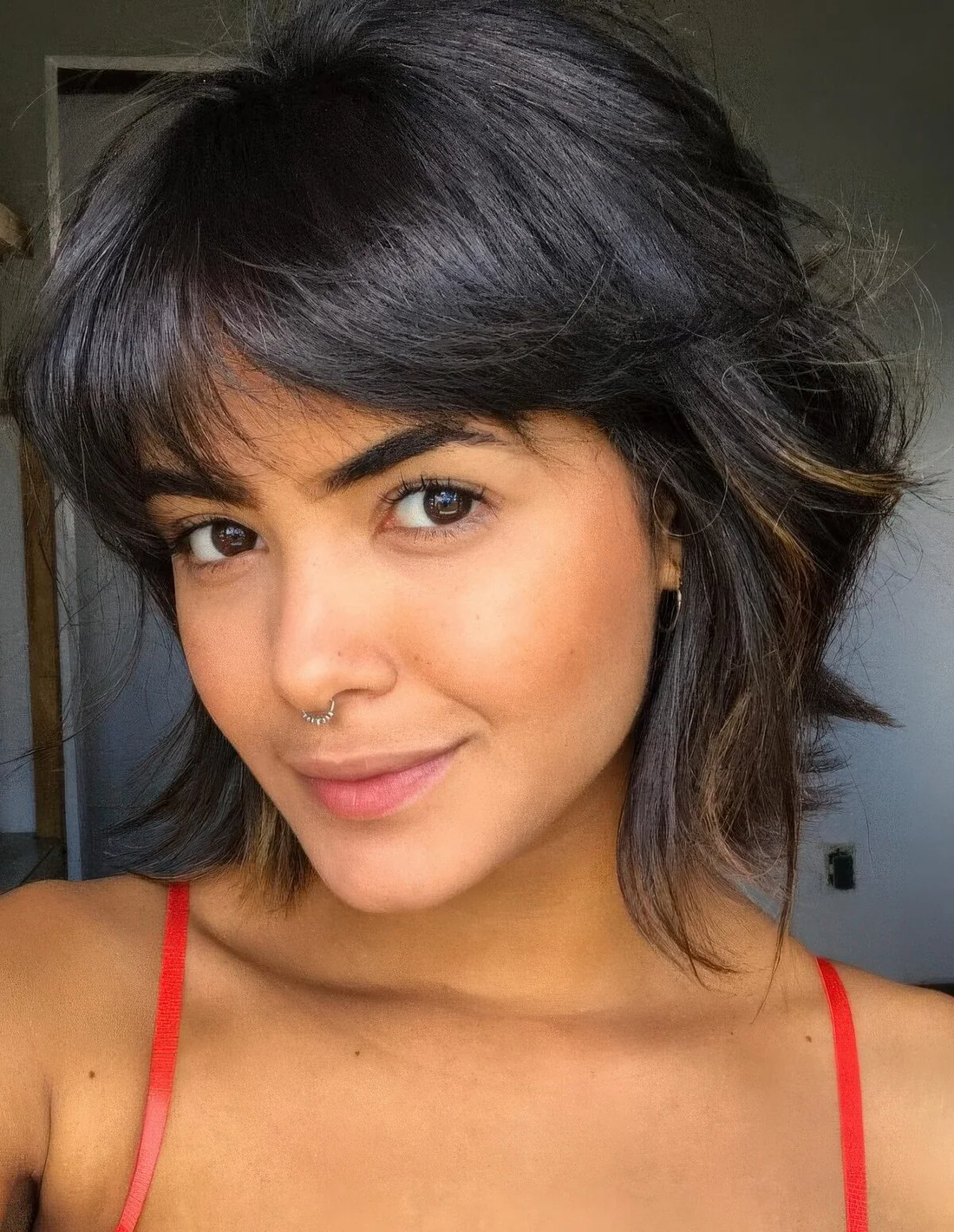 Fringed shaggy black bob with a bit of highlights and a lot of texture.