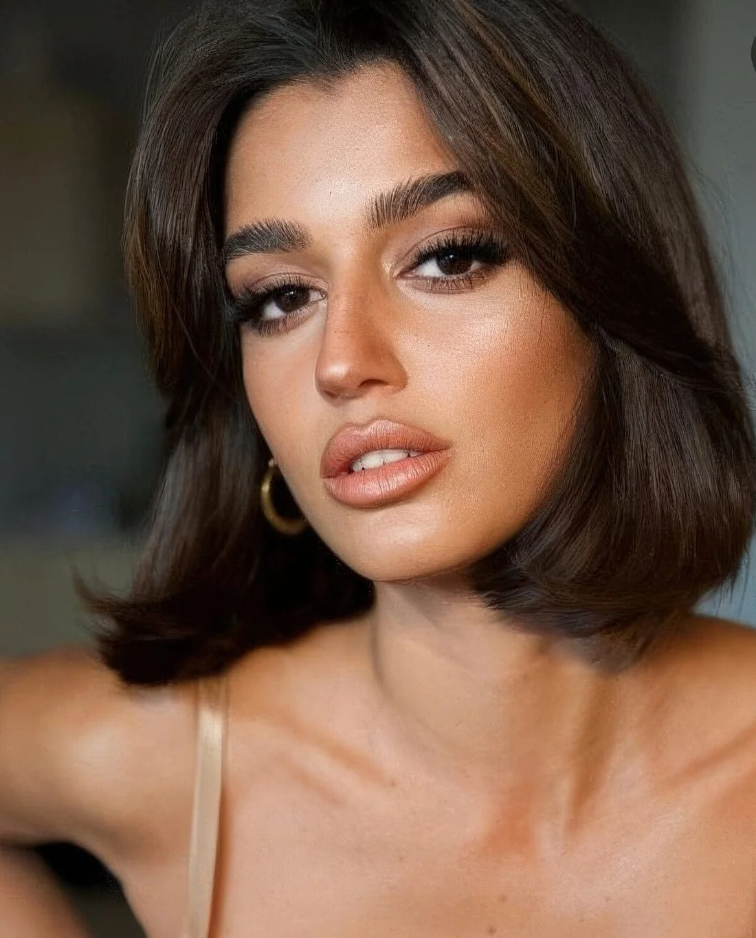 Dark brown liquid bob with center part and side bangs plus wavy ends.