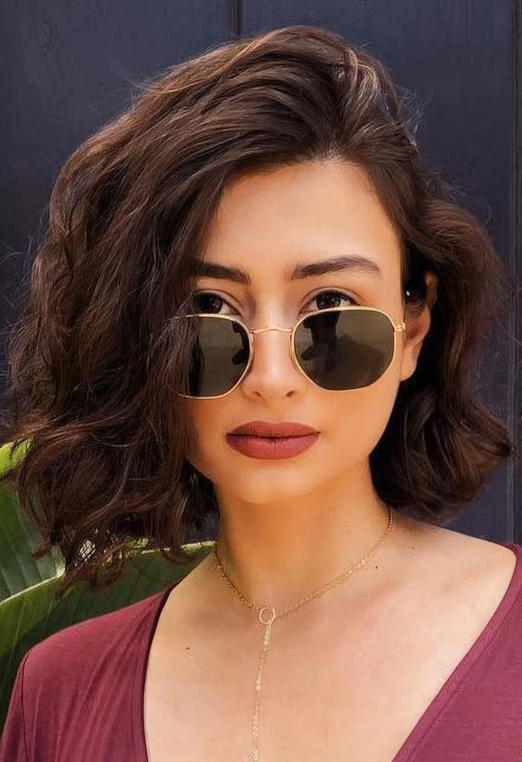 Medium-length dark brunette bob with side part, waves and a lot of volume.