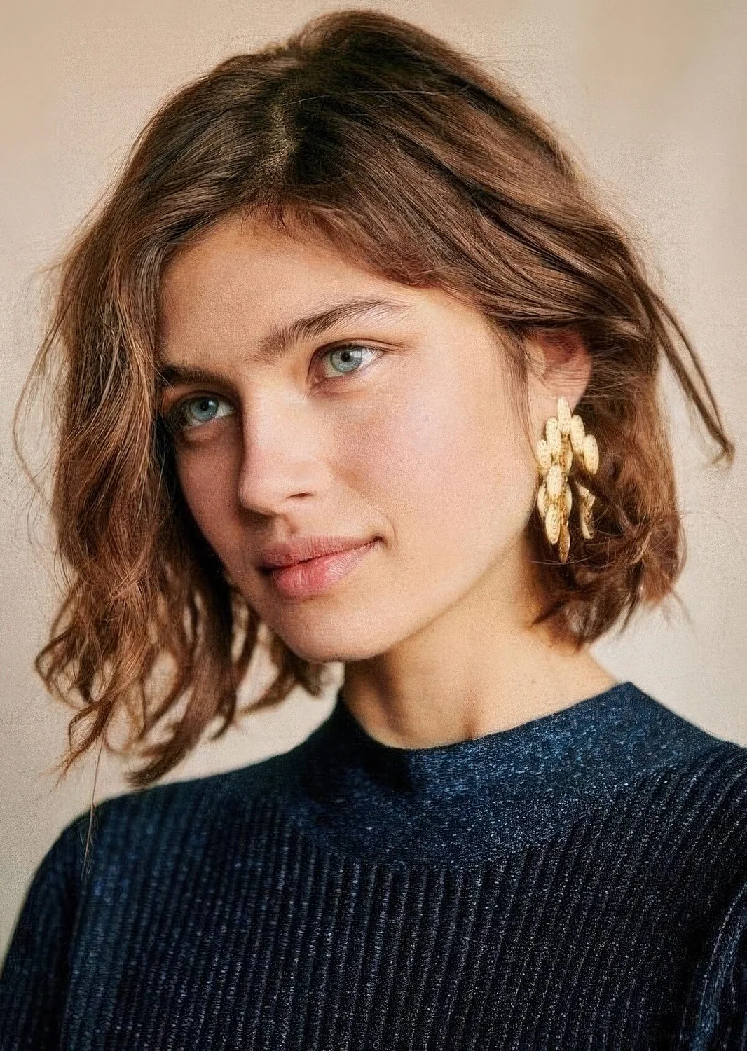 Messy wavy extural brown chin-length bob, with a messy part.