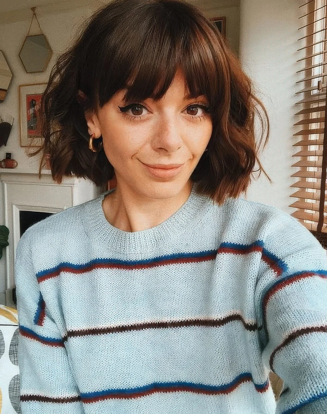 Midi brunette bob with waves and bangs.