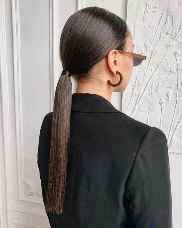 chest straight chestnut ponytail shown as a mother of the bride hairstyles idea, featuring volume through the low volume