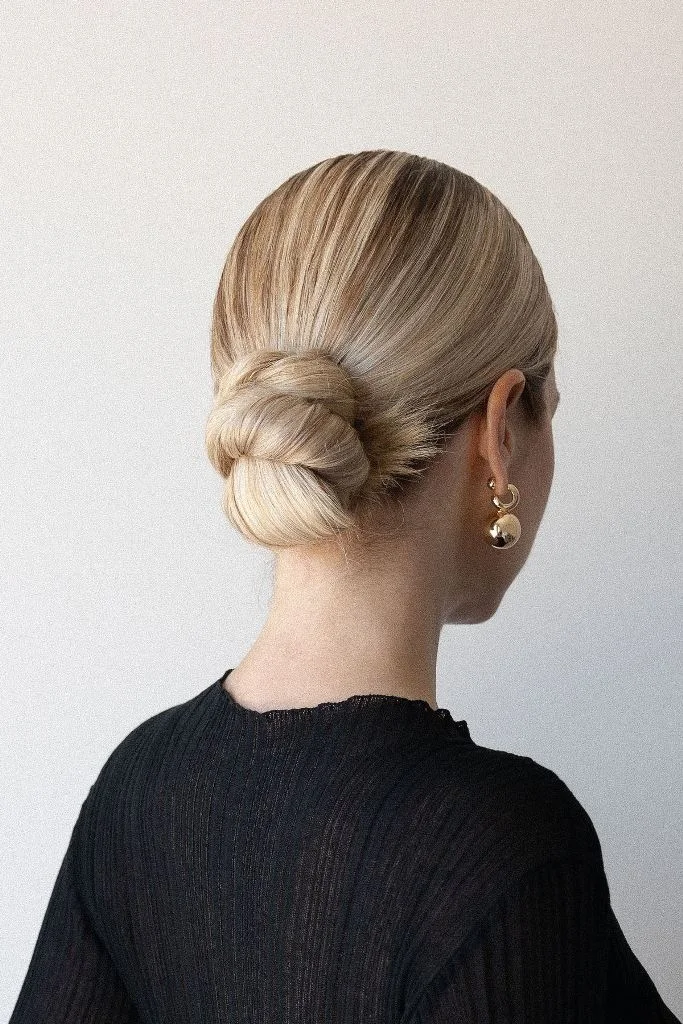 shoulder wavy blonde updo shown as a mother of the bride hairstyles idea, featuring volume through the crown