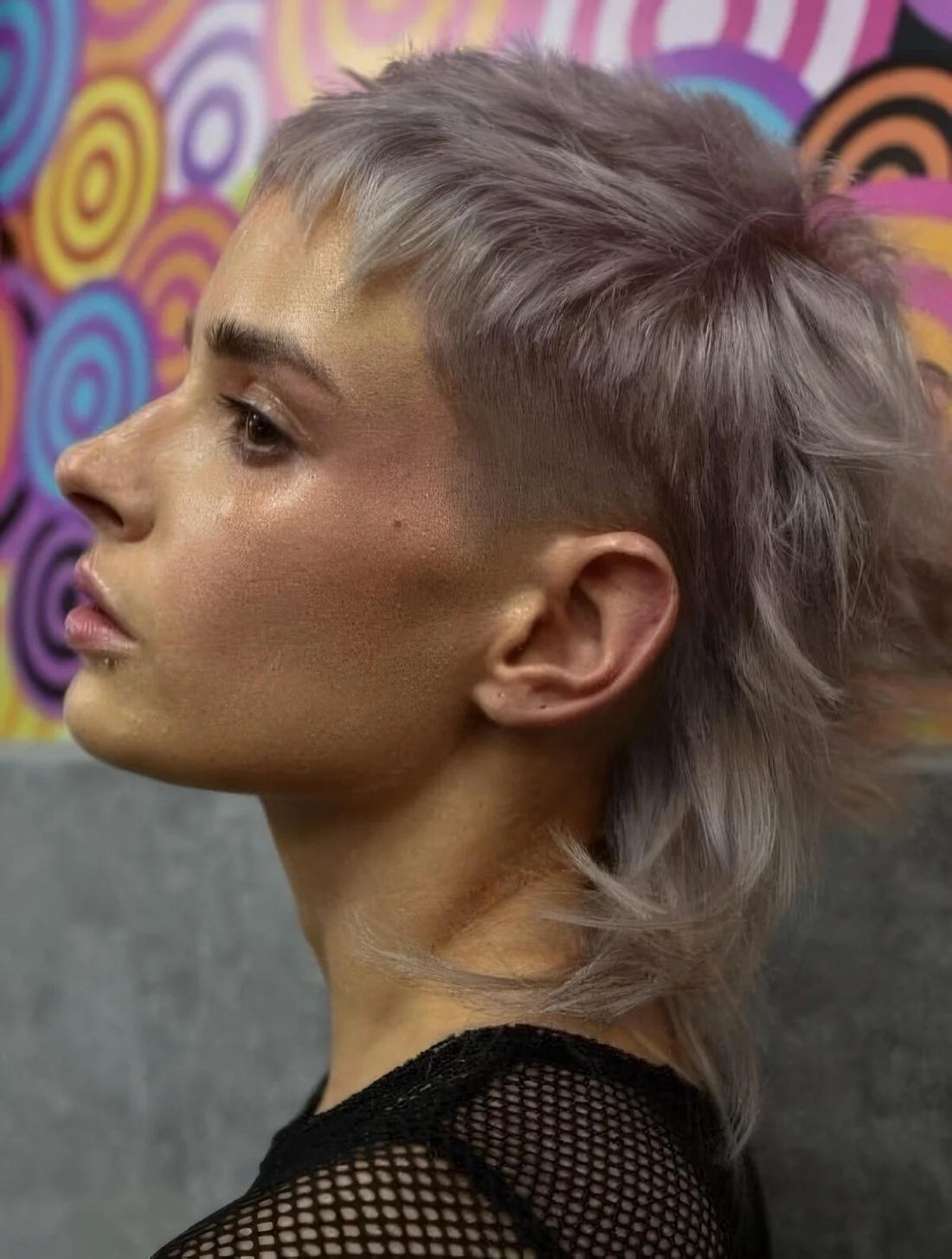 Grey colored mullet with a fade to the sides of the hair to give it structure and create a slight contrast.