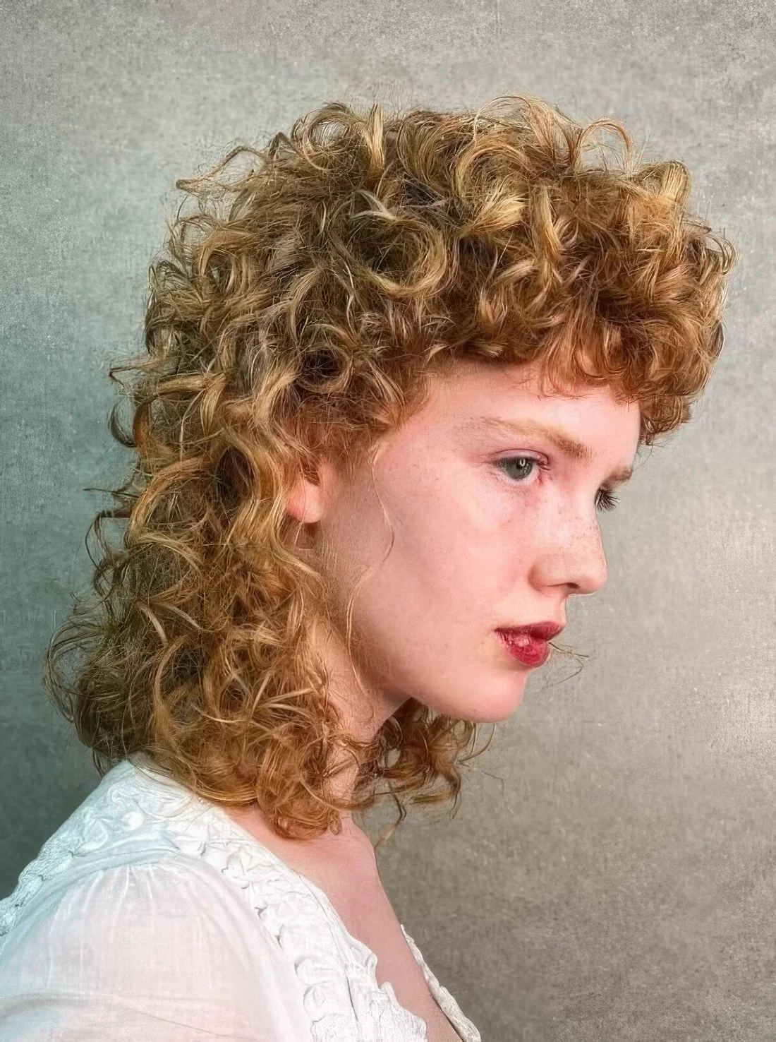 Honey colored permed mullet as perms are great for achieving volume and fullness, and the modern approach.