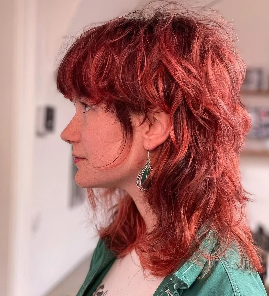 Modern shaggy burgundy colored wavy mullet.