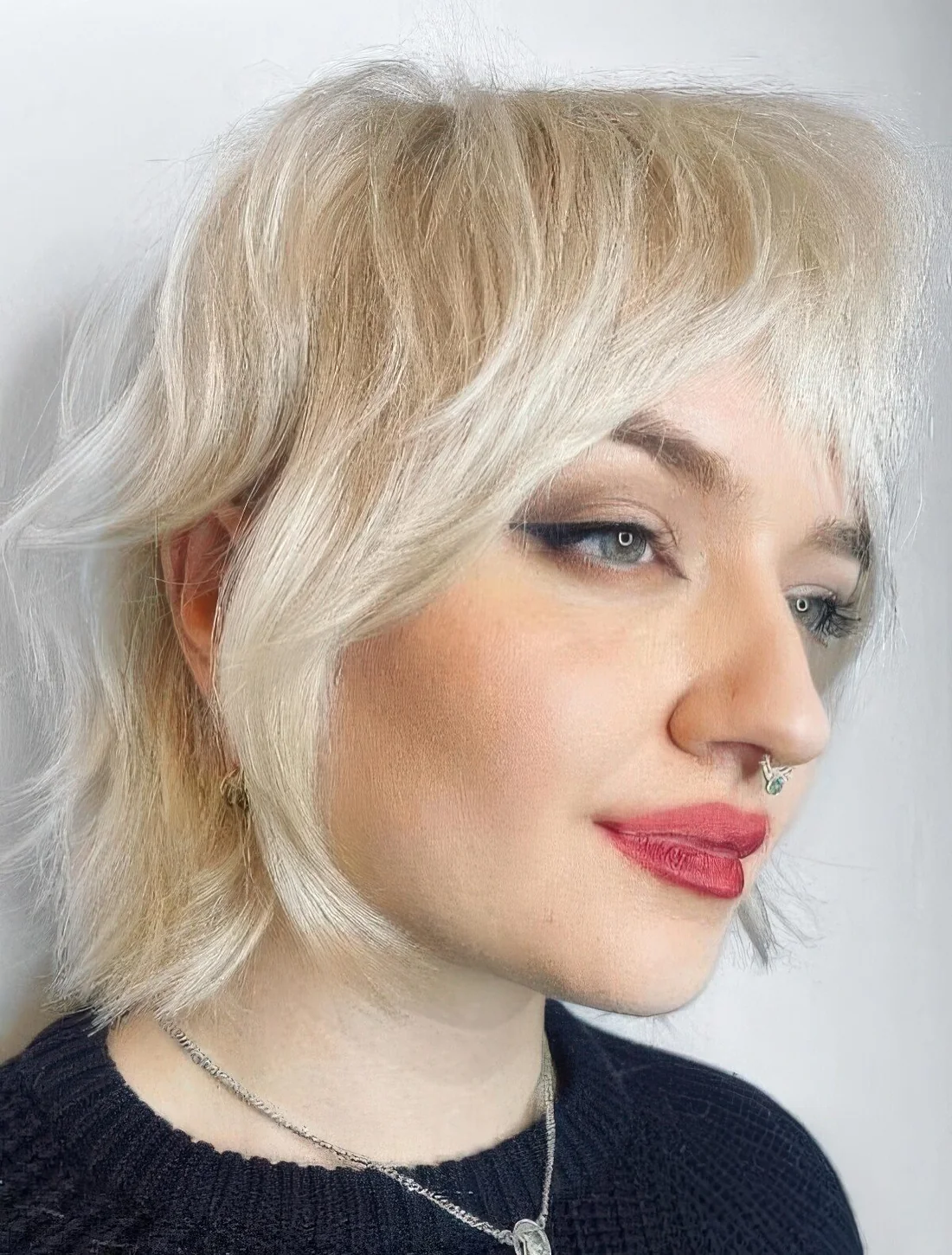 Wavy mullet with longer hair on the top and texture.