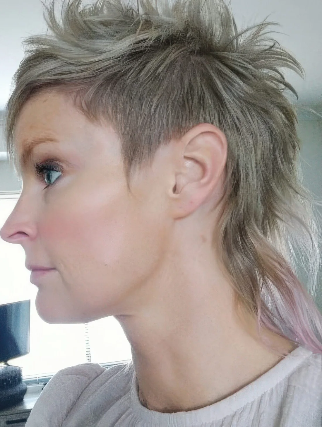 Photo showing mohawk mullet with a textured top, with the hairstyle clearly visible.