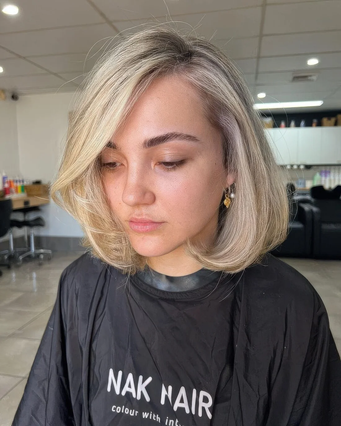 Photo showing blonde curled bob, with the hairstyle clearly visible.