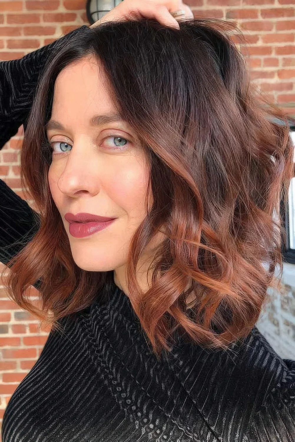 Long dark brunette bob with copper ombre, waves and volume.