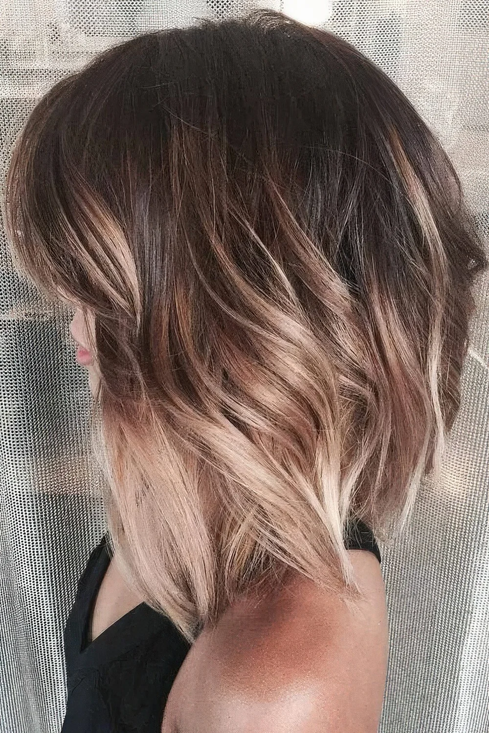 Volumetric long bob in dark brunette, with blonde ombre and some layers.