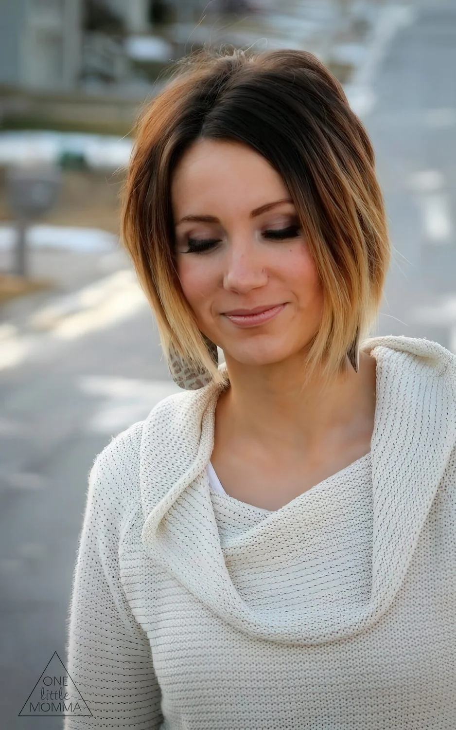 Short asymmetrical bob, dark brown roots and blonde ombre.