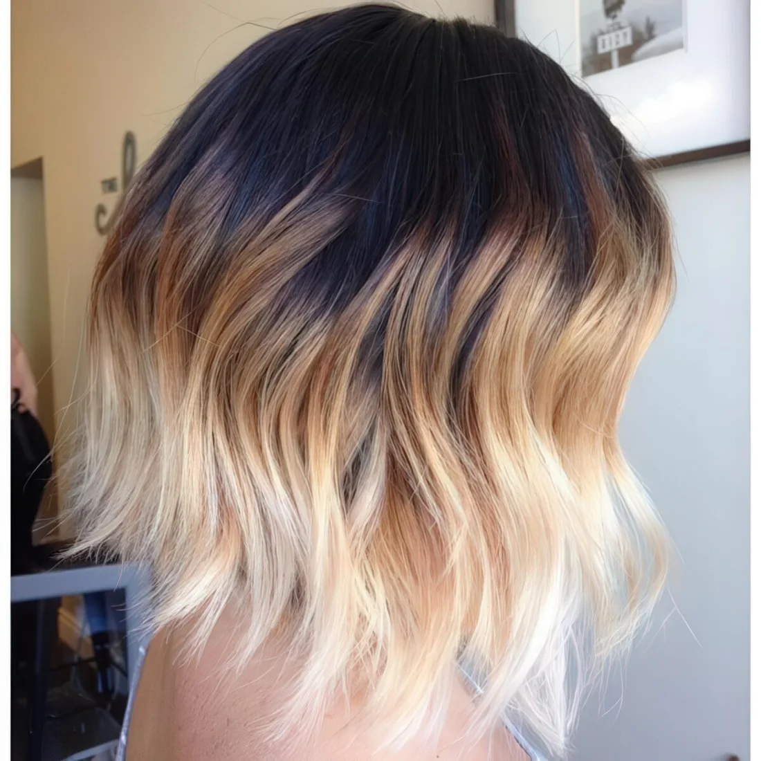 Black roots, bronde and then blonde hair with waves.