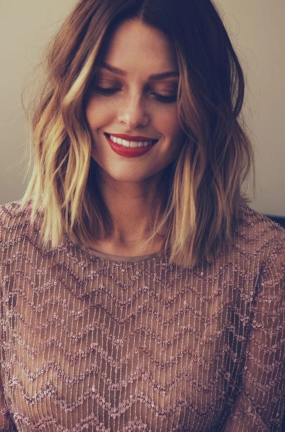 Dark brown outgrown bob with blonde balayage, waves and middle part.
