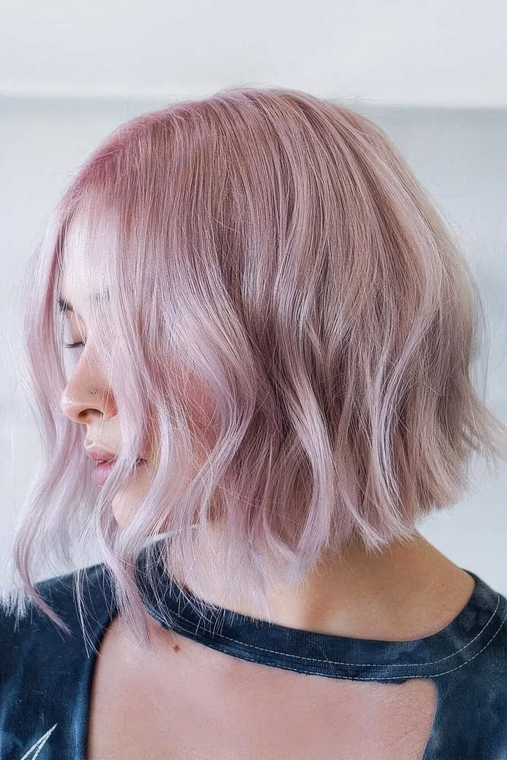Cold pale pink A line bob with waves and bleached touches.