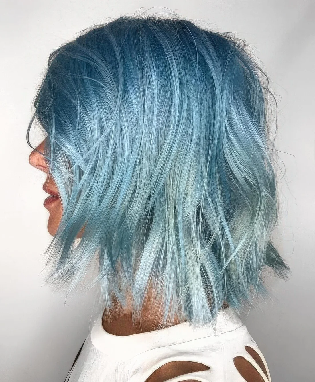 Light blue with an icy tone long bob with layers and messy texture.