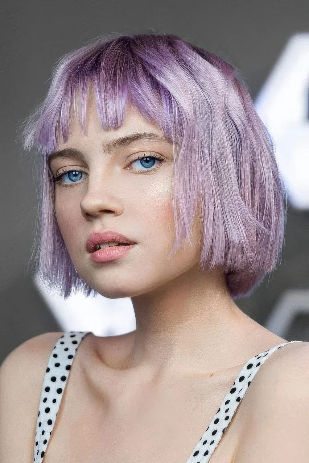 Lilac jaw-length bob with wispy bangs and a bit of texture.