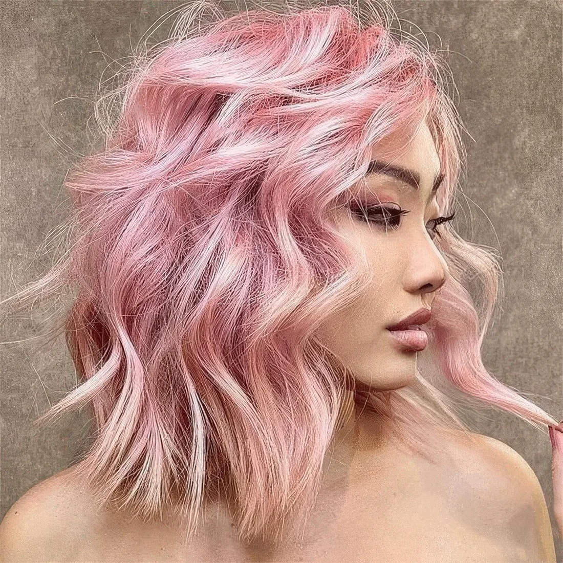 Light pink outgrown bob with messy and textured waves and a lot of volume.