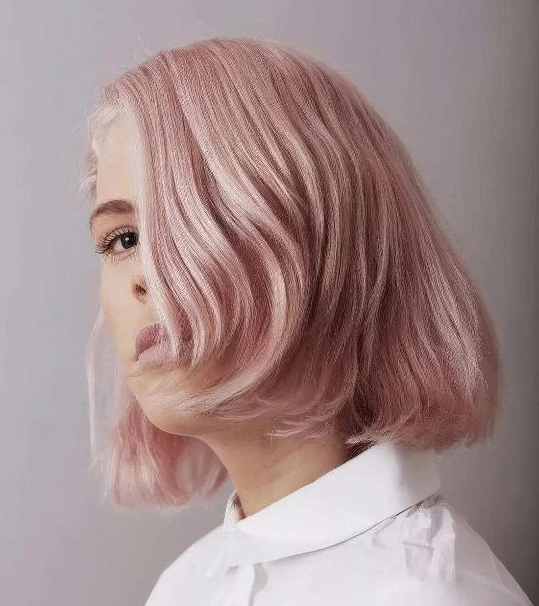 Millennial pink short bob with curved ends.