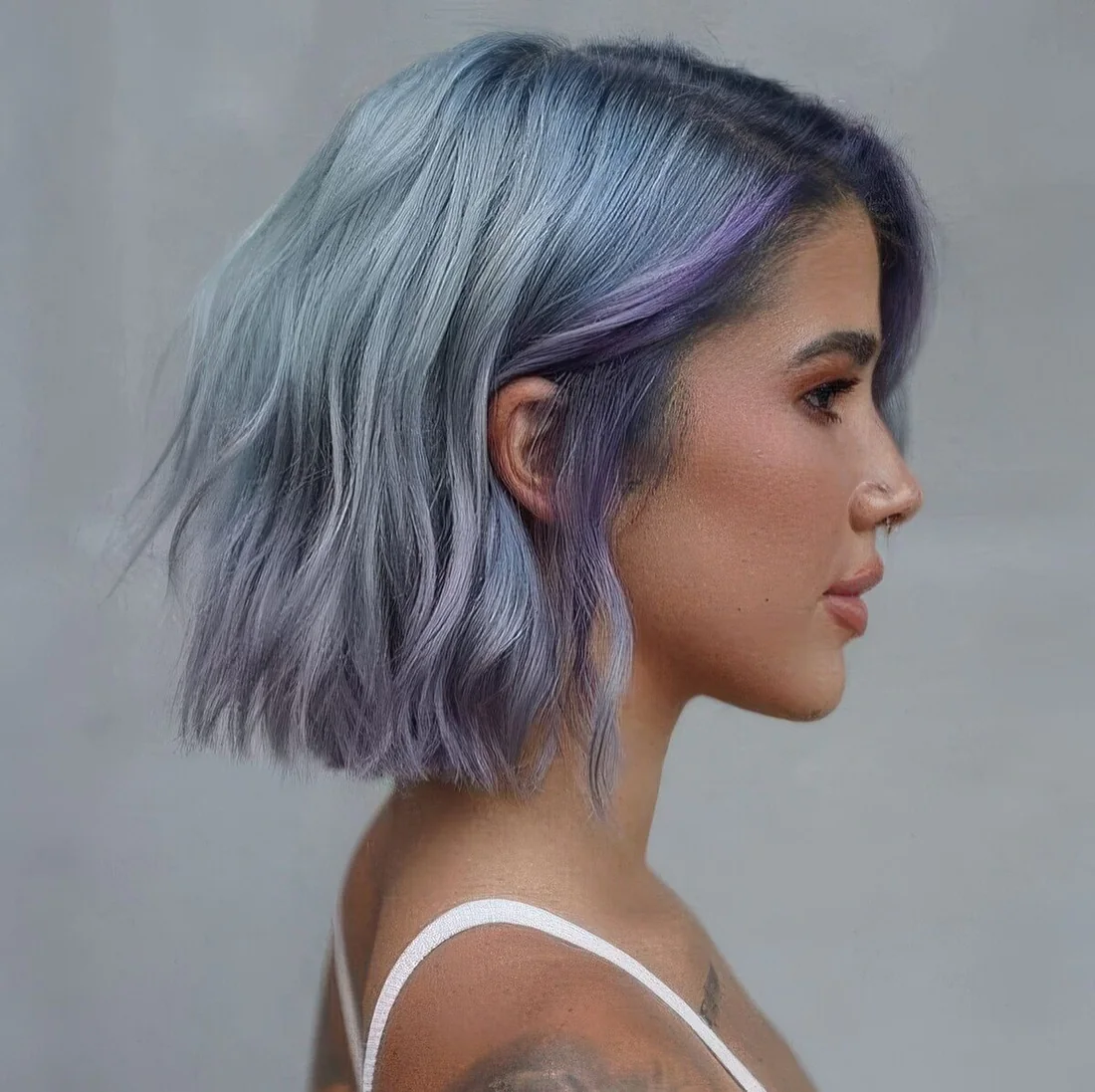 Pale blue choppy long bob with lilac locks and waves plus side part.