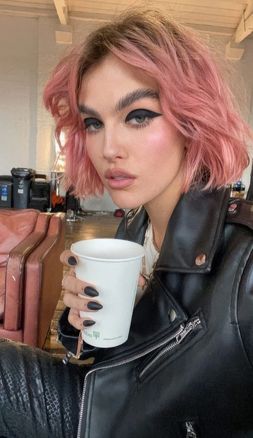 Pink jaw-length bob with a darker root, shaggy layers and a messy texture.