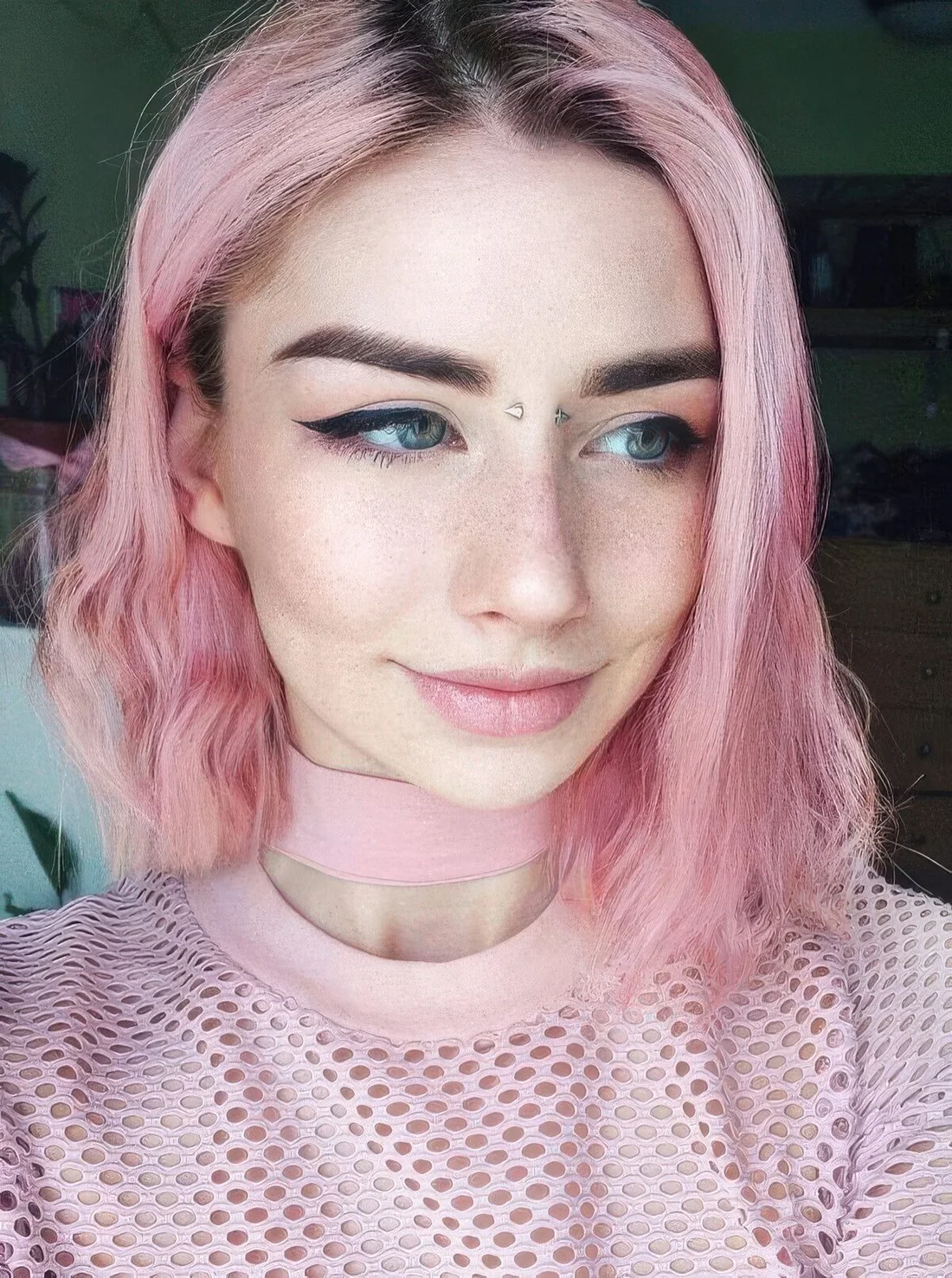 Relaxed pink long bob with a darker root and messy waves.