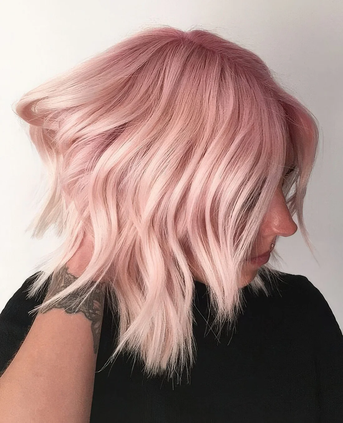 Soft pink long bob with waves and a slight ombre effect.