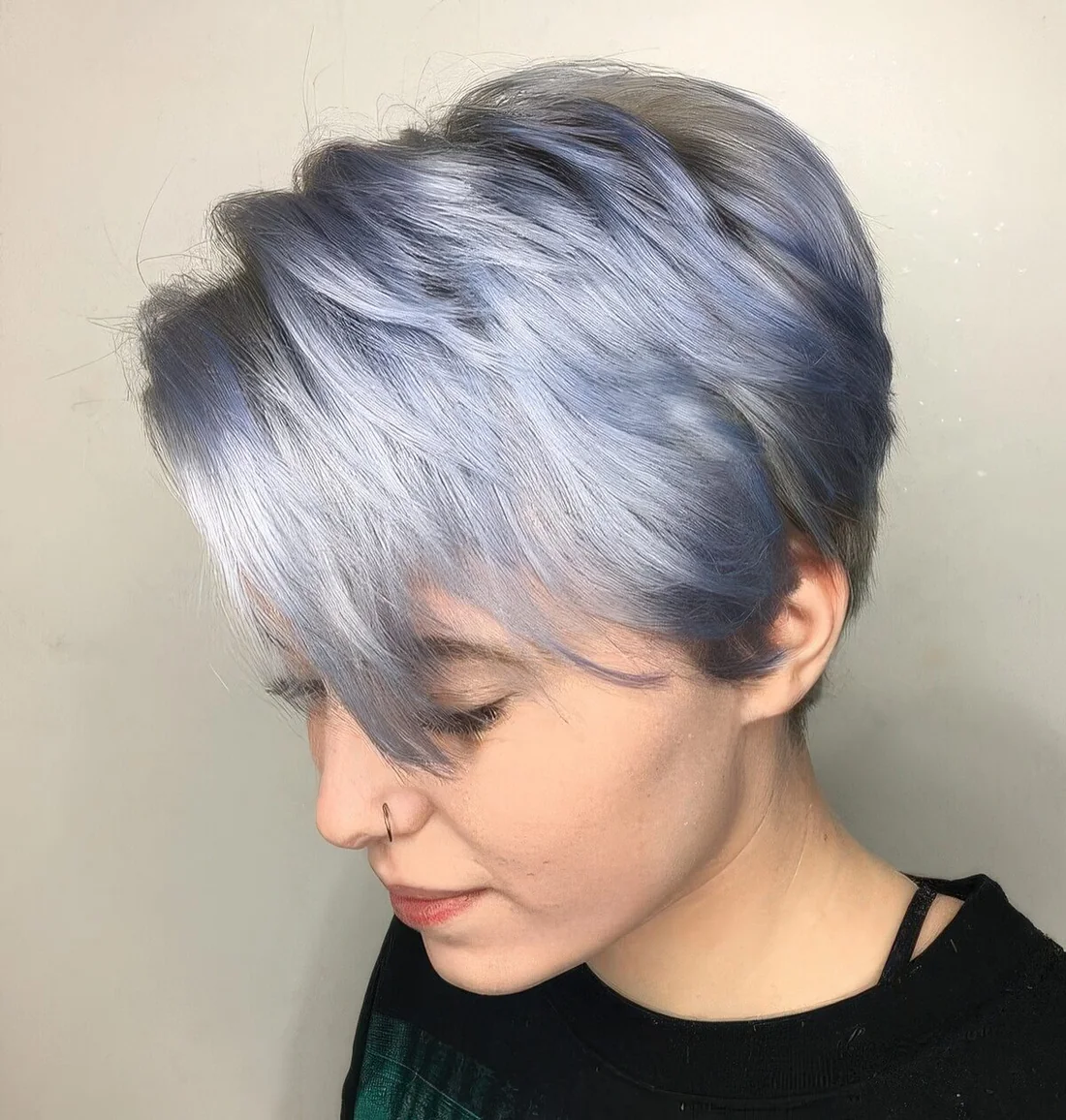 Silver and pastel blue long pixie, with side bangs and volume.