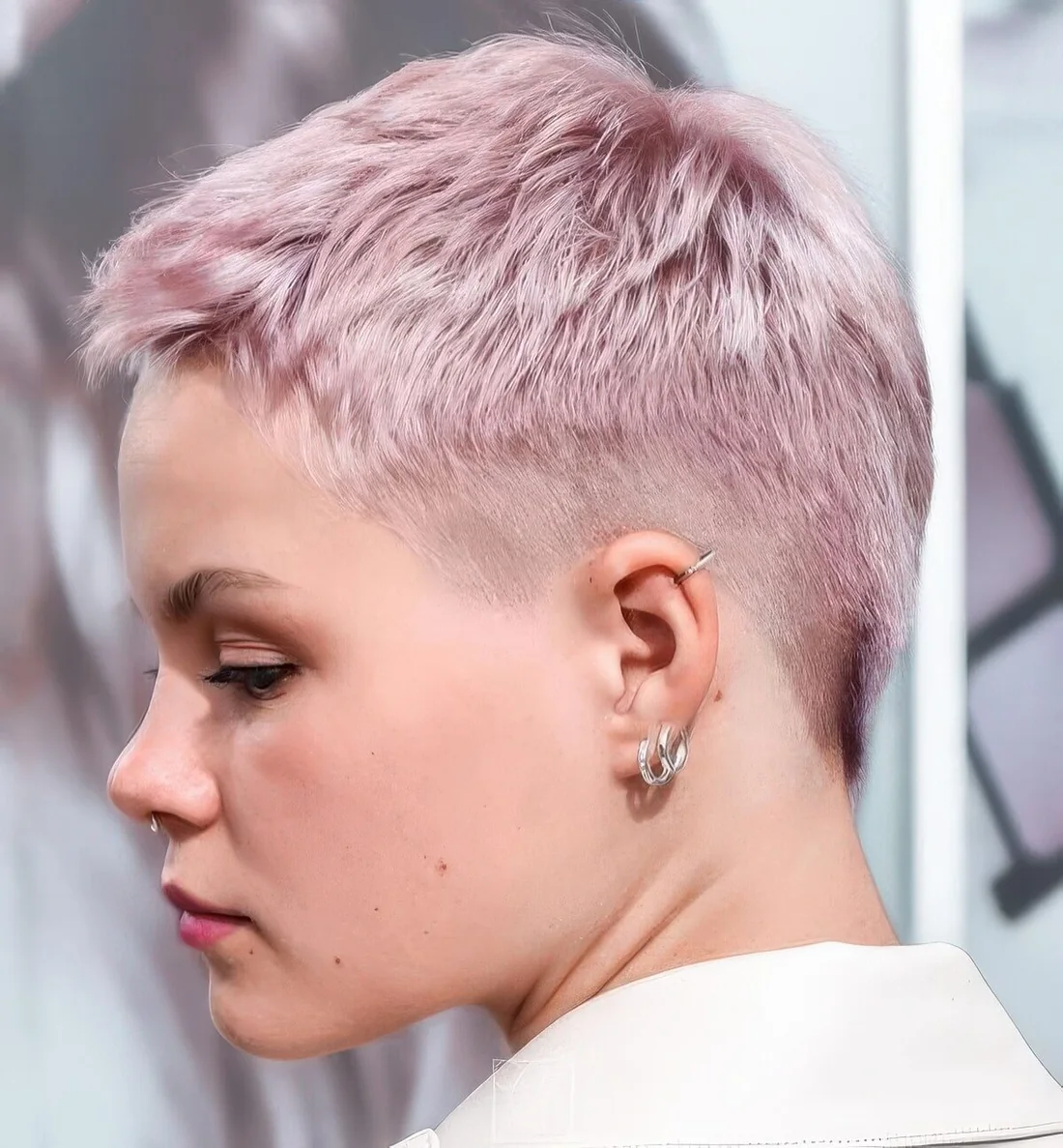 Pastel pink short pixie cut with an undercut.