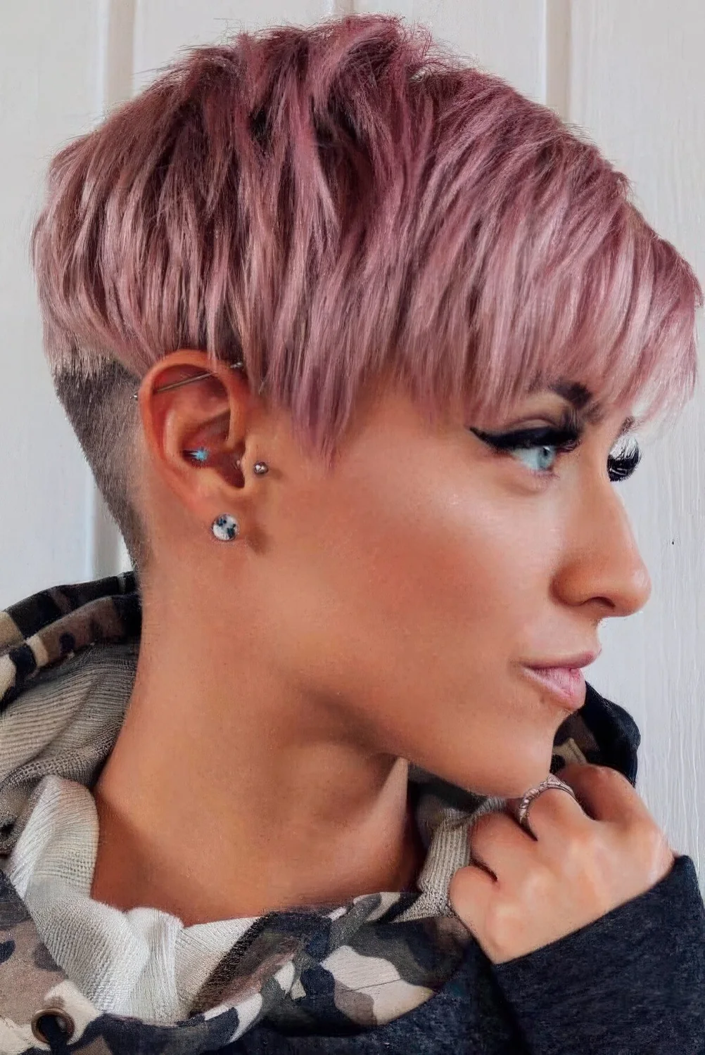 Layered and textured long pixie with side bangs and an undercut.