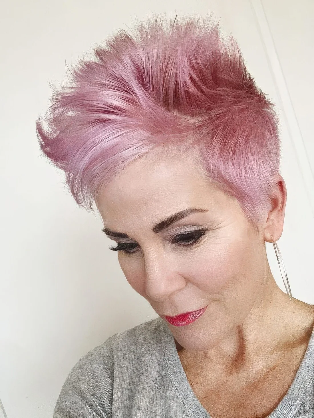 Long pink pixie styled up, with a lot of volume and texture.