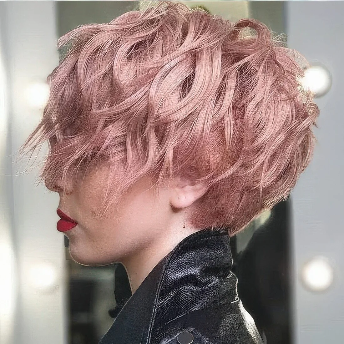 Long wavy pink pixie with long bangs and volume.