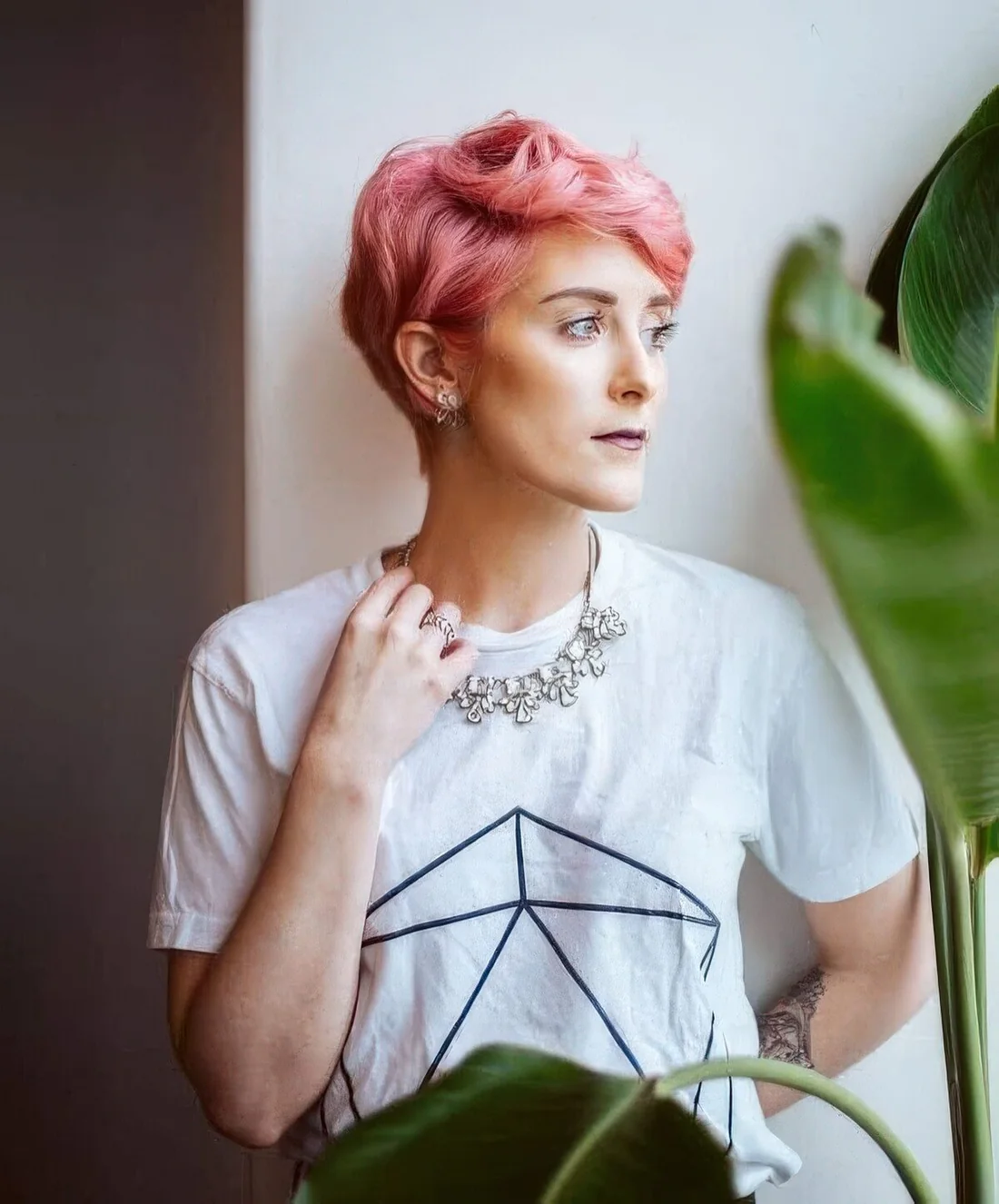 Photo showing long wavy pink pixie with volume, with the hairstyle clearly visible.