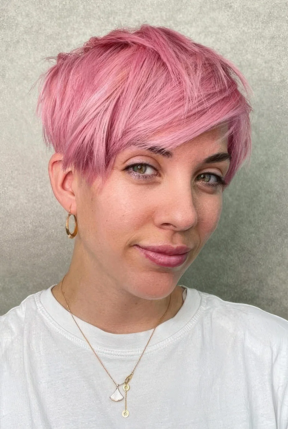 Messy asymmetrical long pixie in pink.