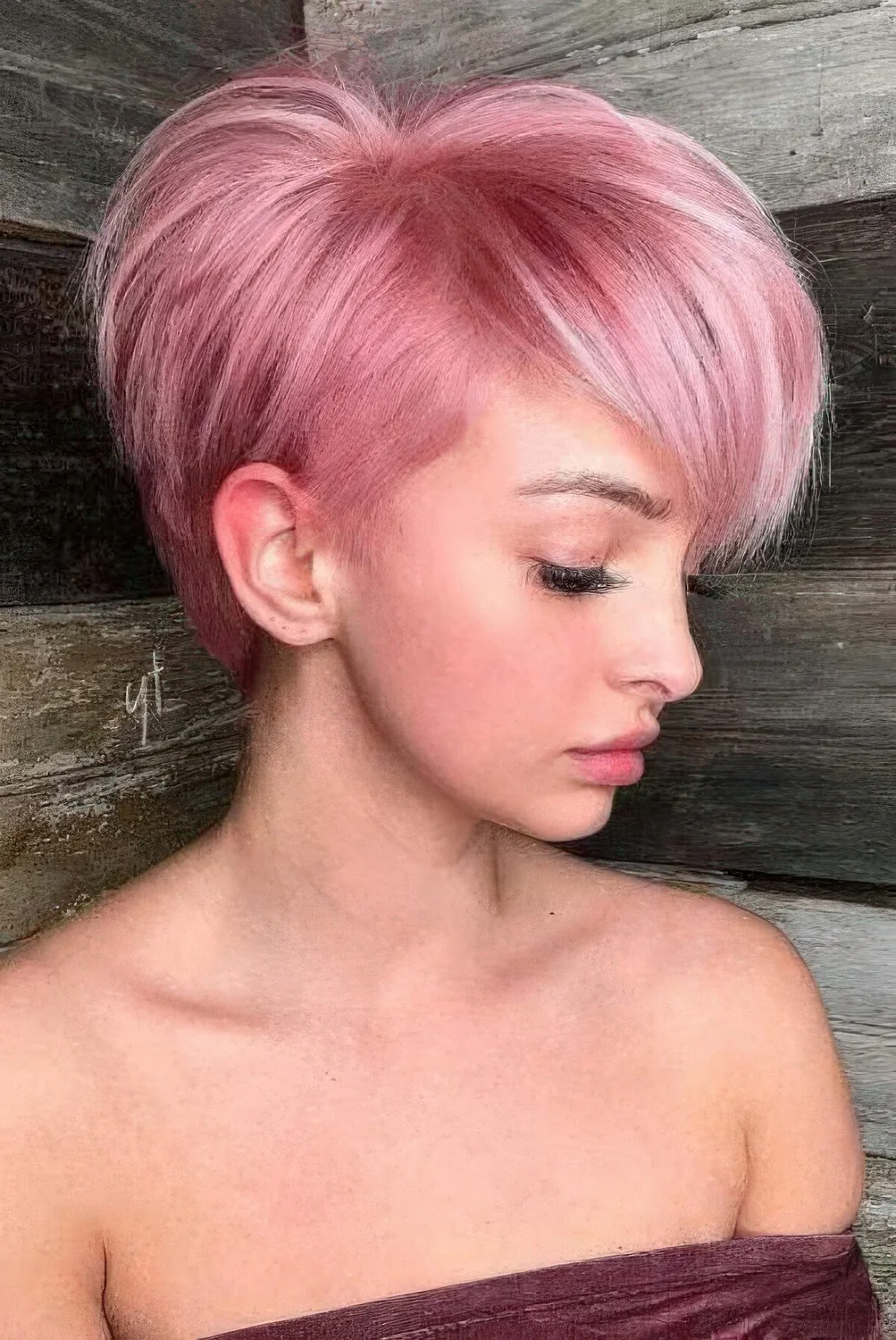 Pastel pink long pixie bob with a lot of volume and texture.