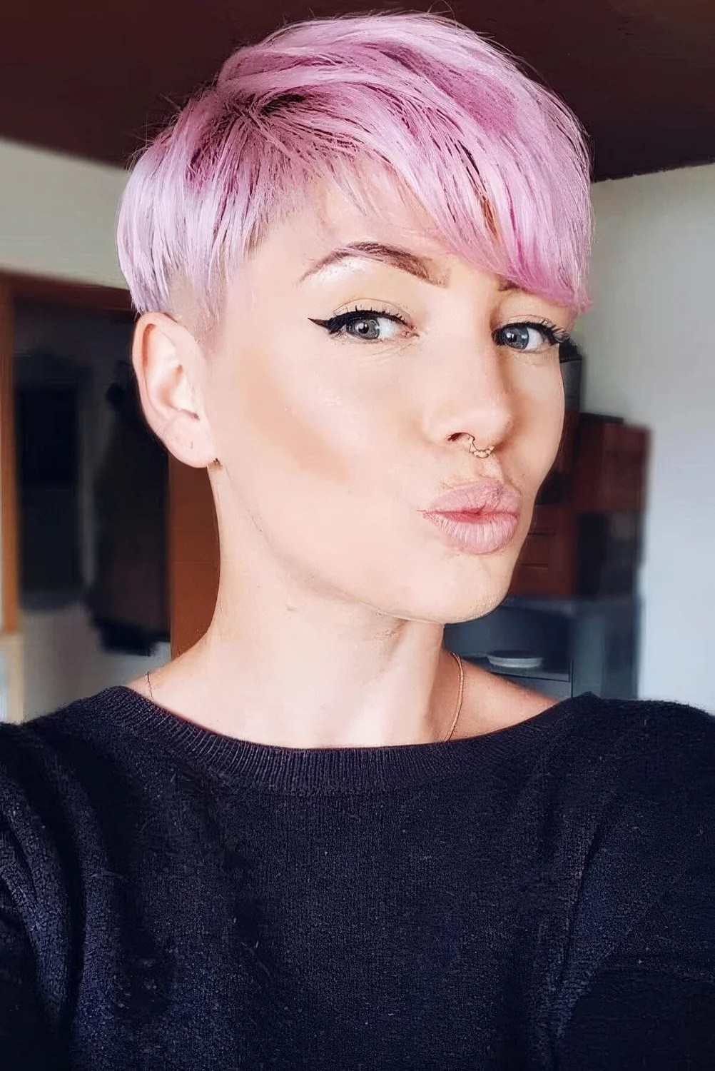 Pastel pink long pixie with long side bangs.
