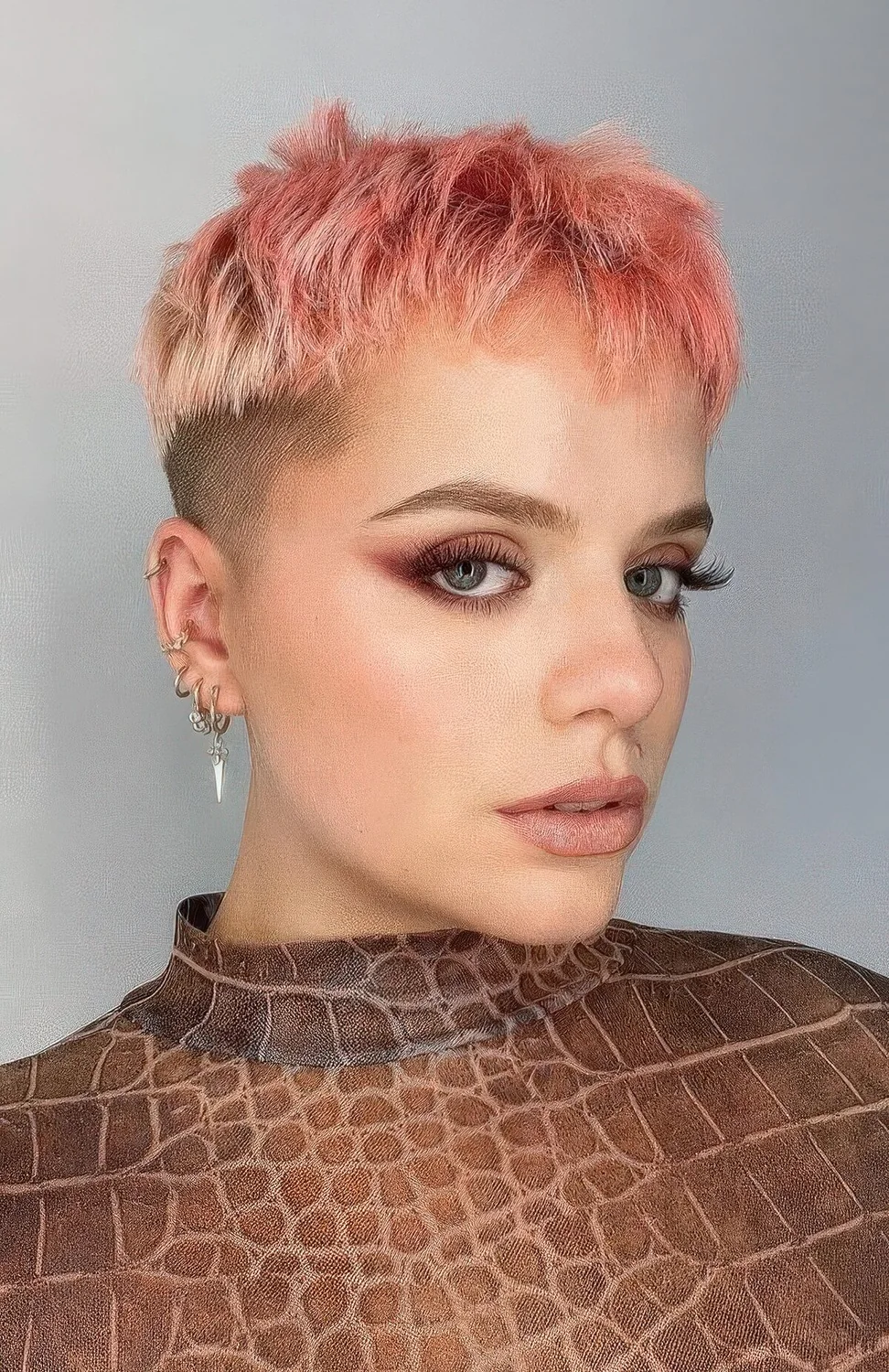 Pink pixie with an undercut and longer hair on top.