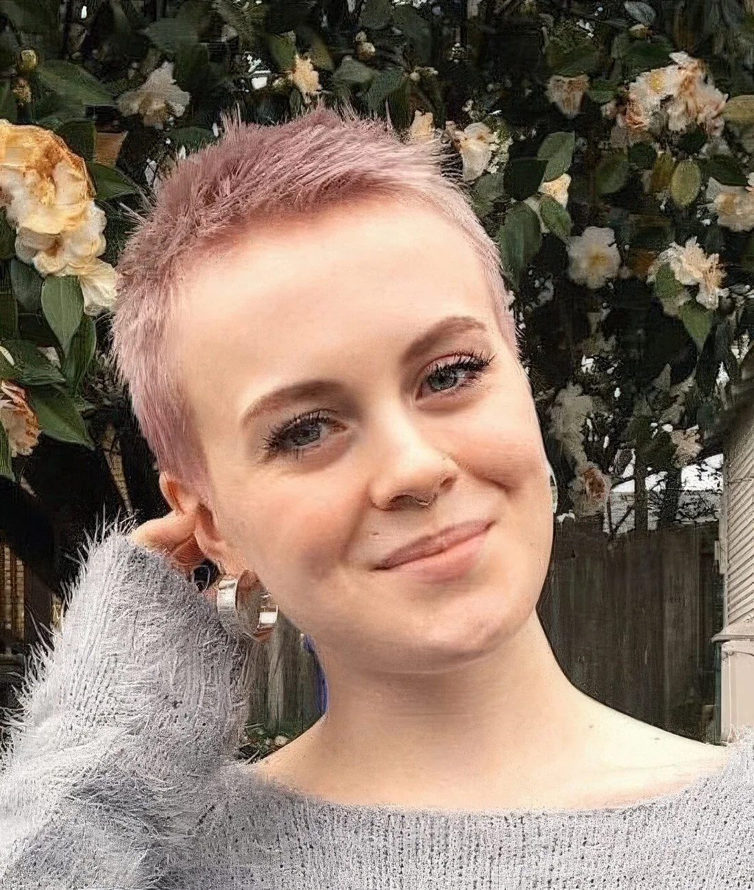 Photo showing extremely short pink pixie, with the hairstyle clearly visible.