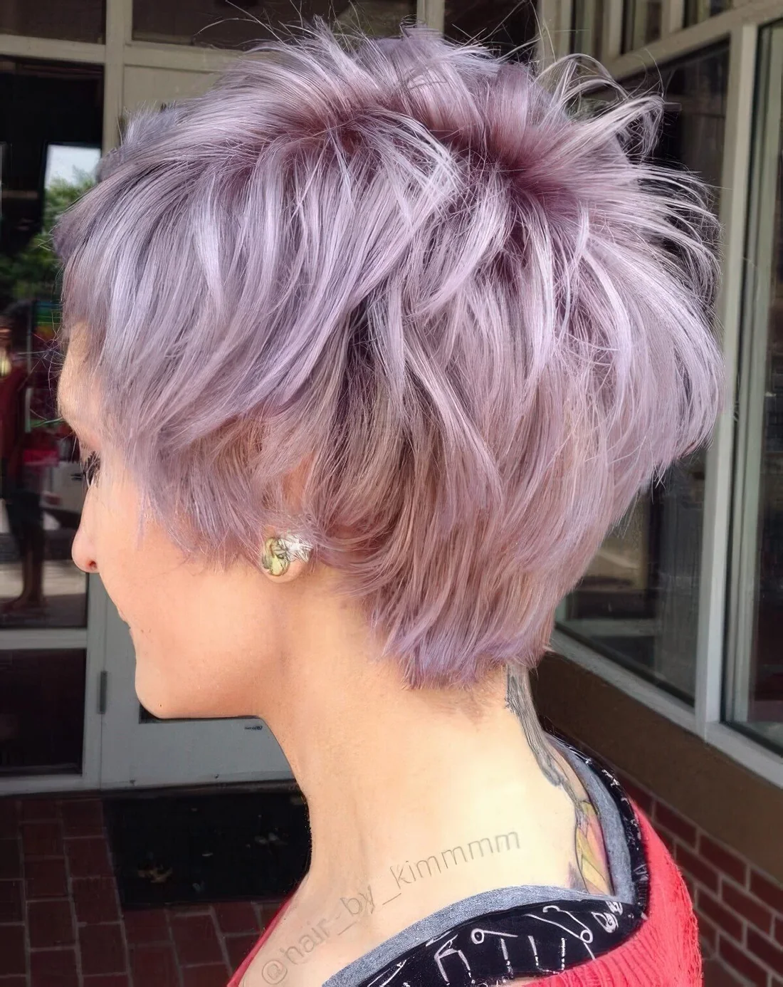 Long lilac shaggy pixie haircut with a lot of volume.