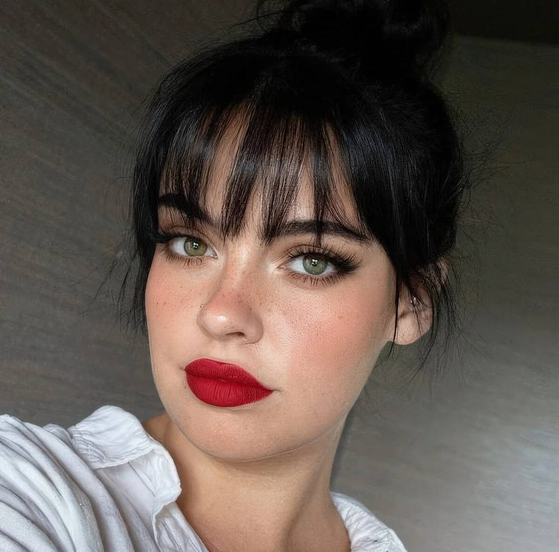 Photo showing black piecey wispy bangs, with the hairstyle clearly visible.
