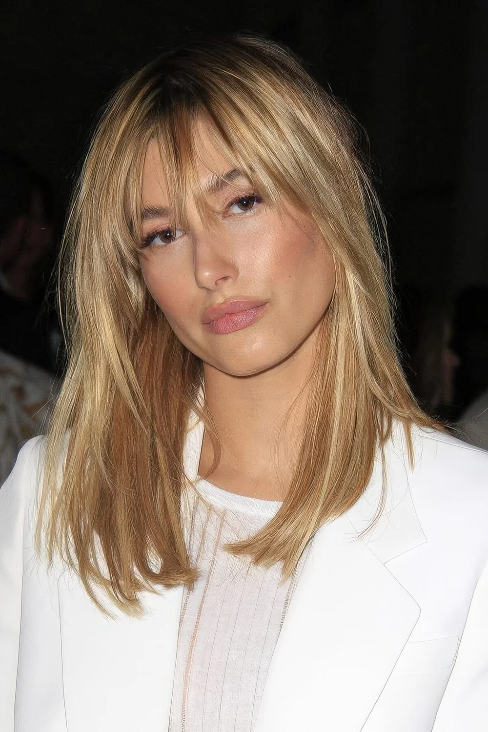 Photo showing medium blonde bangs, with the hairstyle clearly visible.