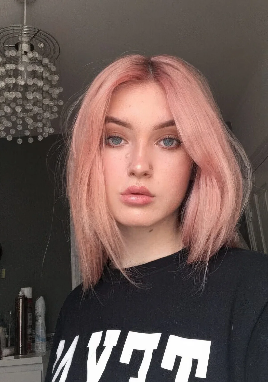 Warm pastel strawberry blonde with a darker root and much texture.