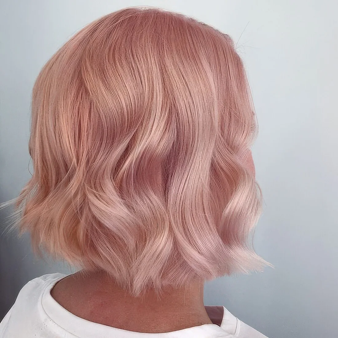 Photo showing rose gold bob with waves, with the hairstyle clearly visible.
