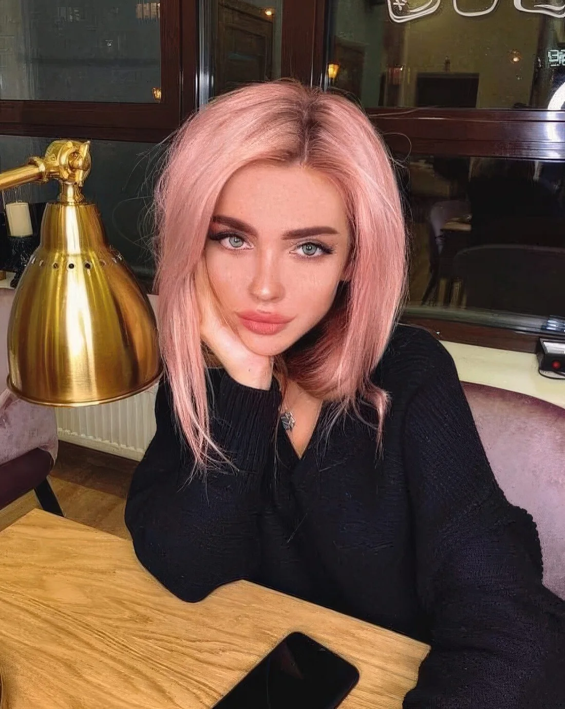 Photo showing pastel pink long bob, with the hairstyle clearly visible.