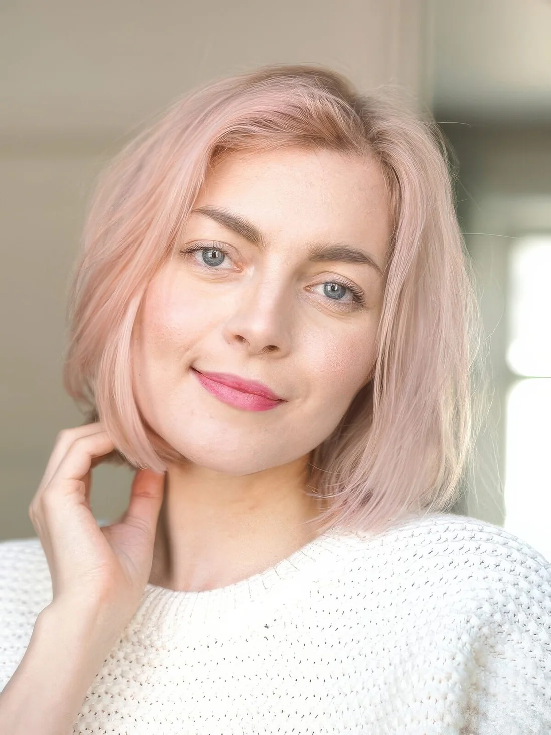 Romantic blush blunt bob with a darker root, side part and texture.