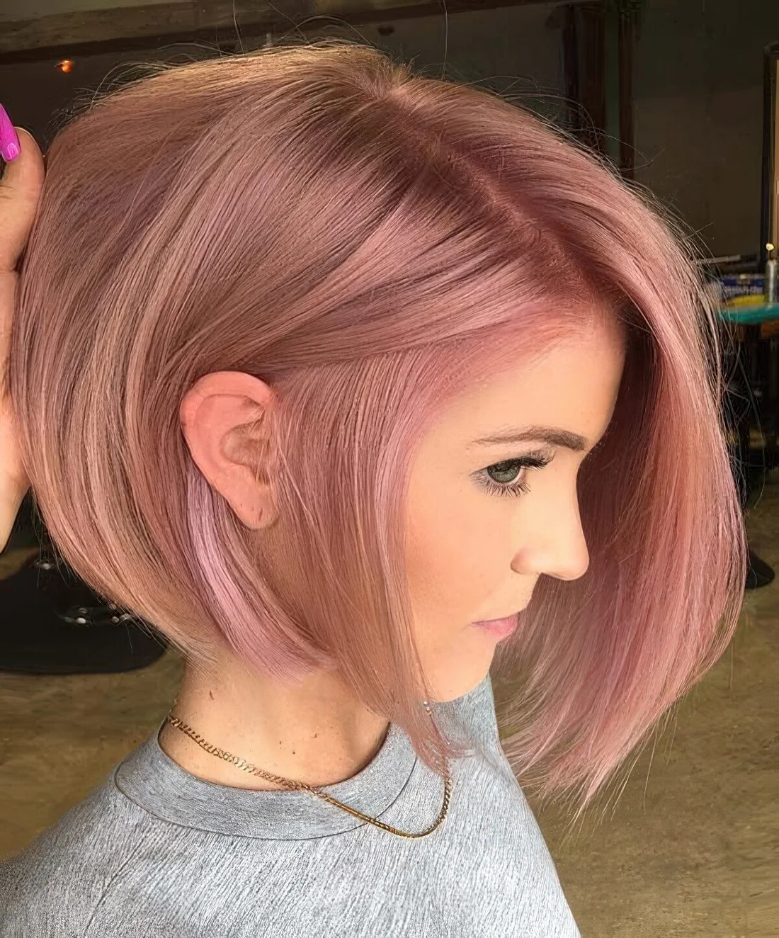 Strawberry pink chin-length bob with a lot of volume and side part.