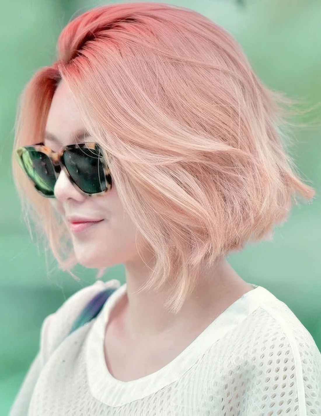 Hot to light and pale pink ombre chin-length bob with a lot of volume.