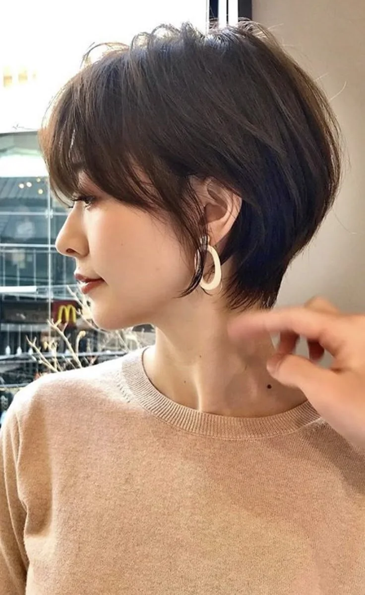 Photo showing french bangs, with the hairstyle clearly visible.