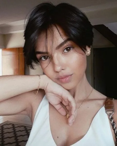 Photo showing long wispy bangs, with the hairstyle clearly visible.